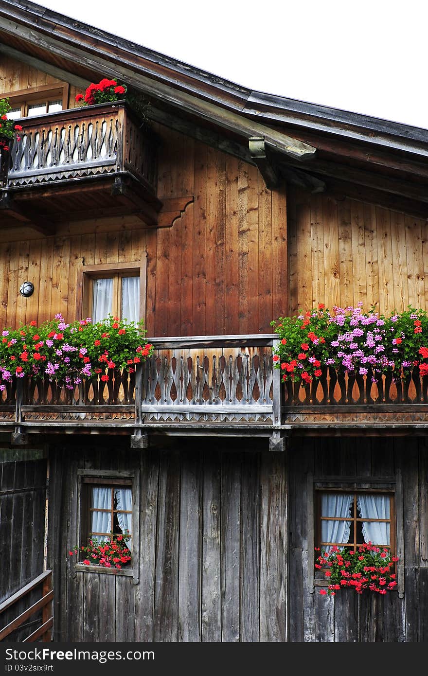 Typical alpine house with balcony and flowers. Typical alpine house with balcony and flowers.