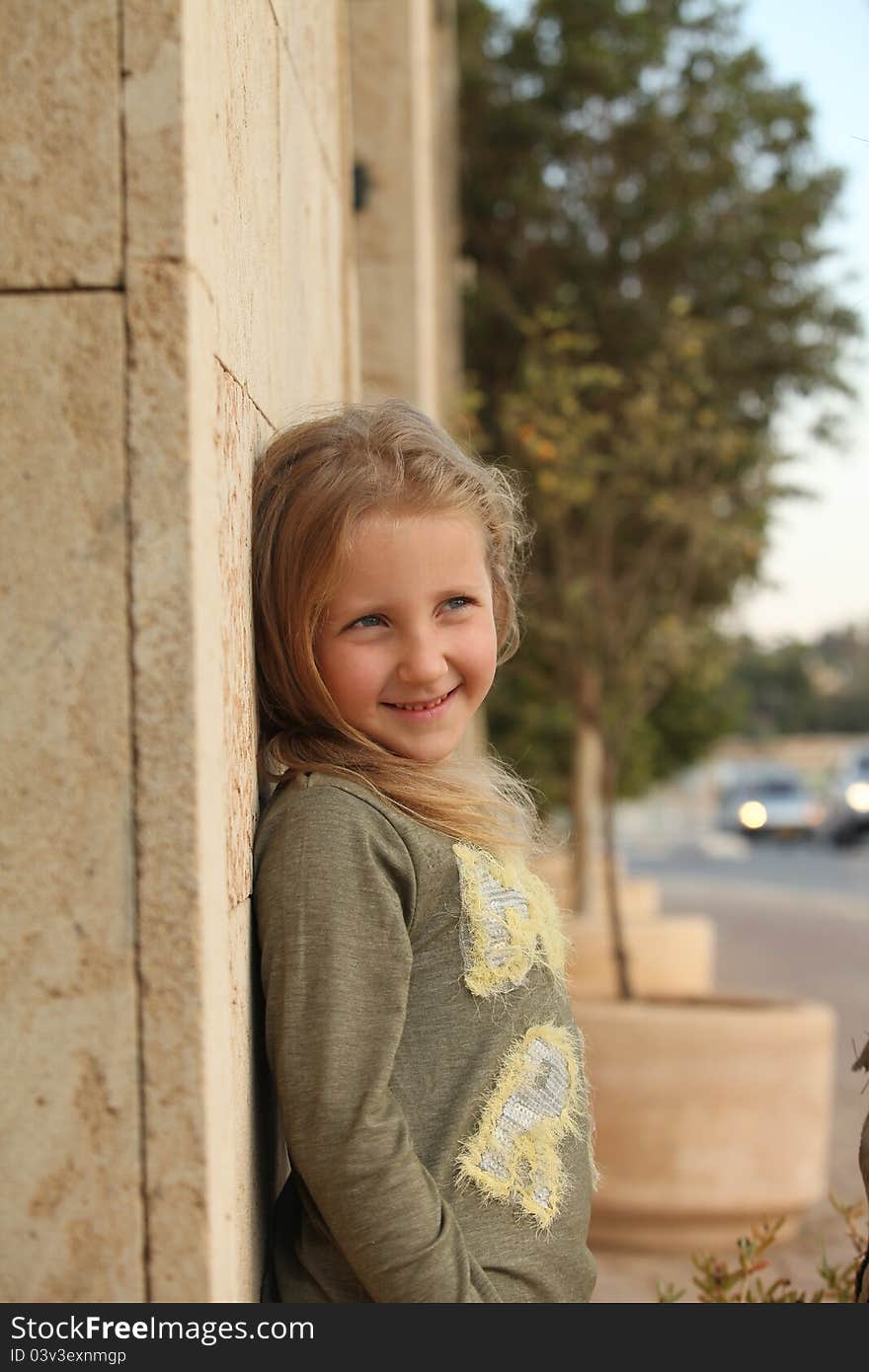 Girl posing against a wall