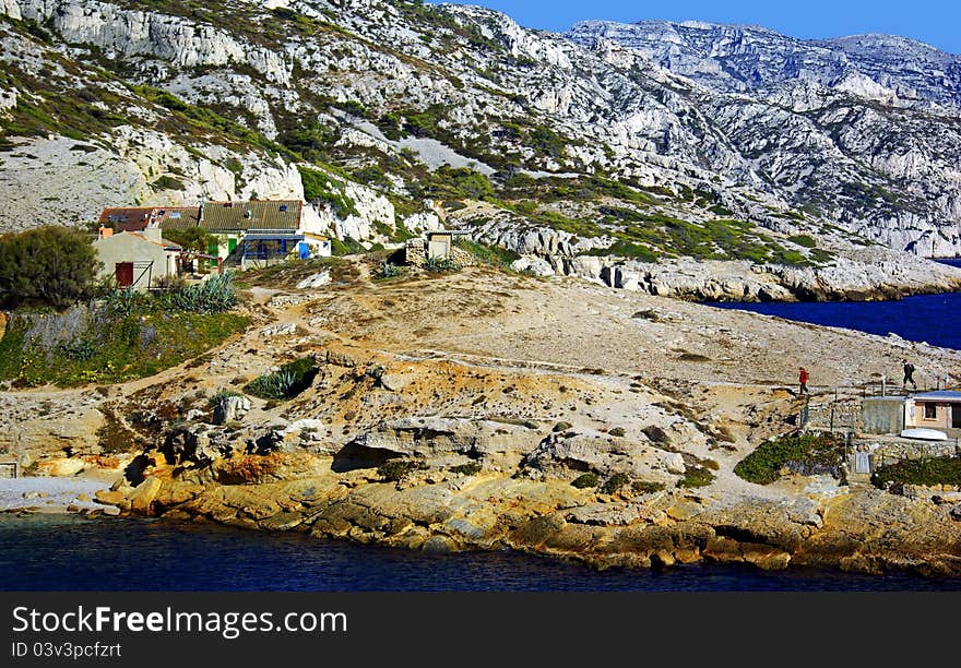 People having a walk in the calanques : steep-walled inlet, cove, or bay that is developed in limestone, dolomite and found along the Mediterranean coast.