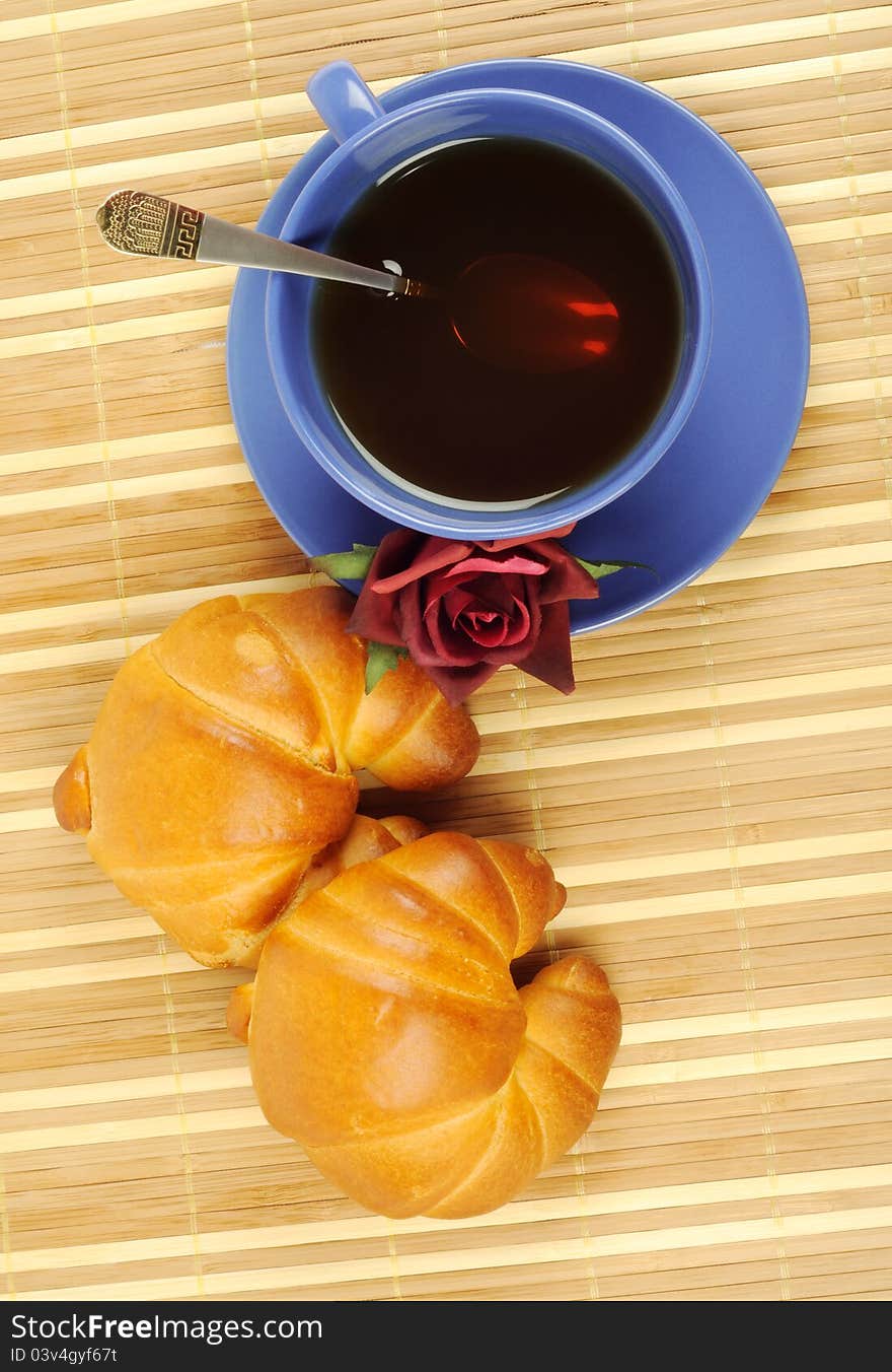 Tea, croissant and rose