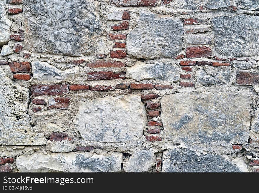 Ancient stone with damaged pattern and weathered