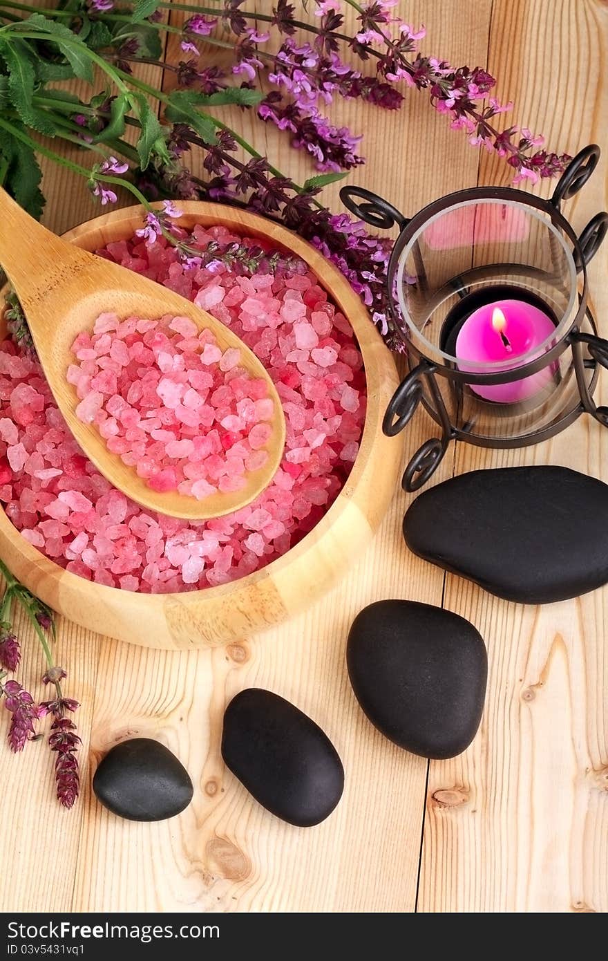 Candle, stones and salt on a wooden background. Candle, stones and salt on a wooden background