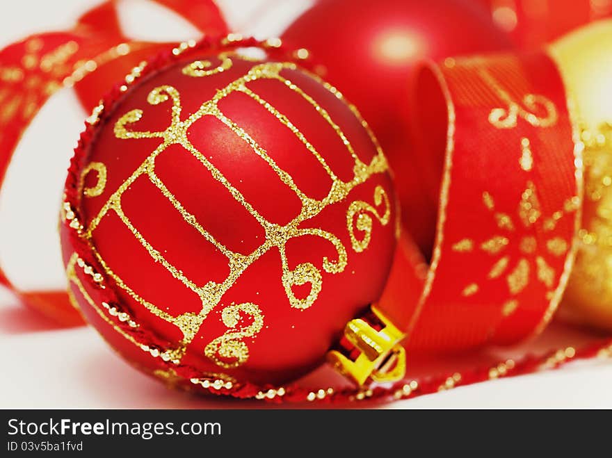 Christmas baubles with curly ribbon  on white