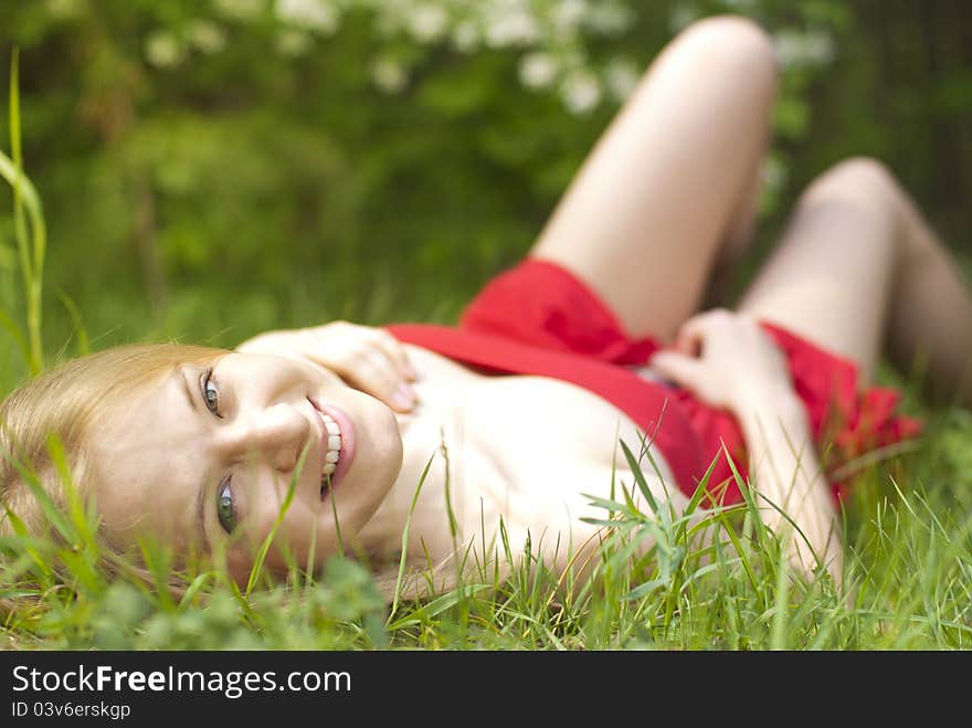 Beautiful blond girl laying in grass. Beautiful blond girl laying in grass