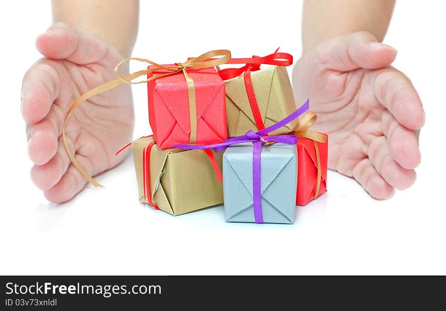 Hands presenting severall small gift boxes