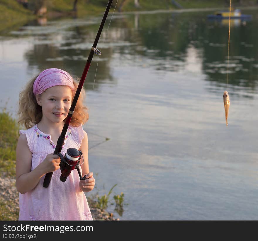 Young girl catches her first fish. Young girl catches her first fish