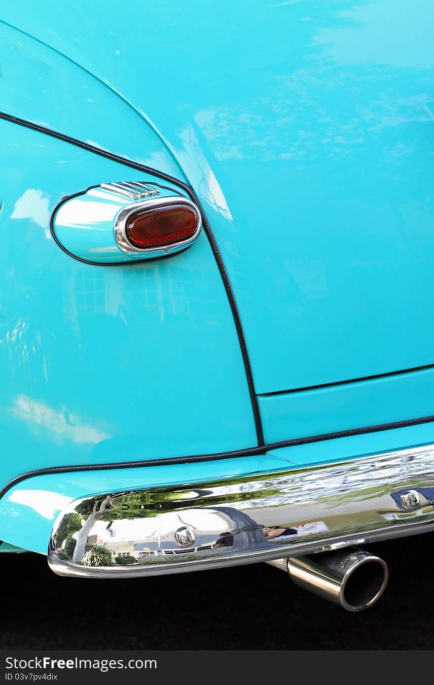 Close Up Detail Of Blue Vintage Car Tail Light, Rear Bumper And Exhaust Pipe