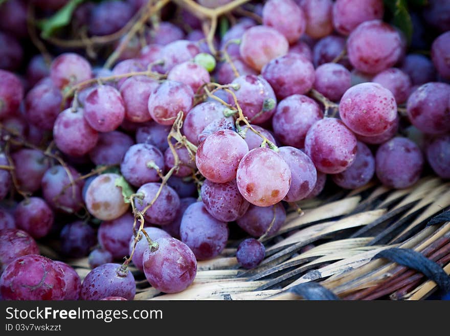 Close up shot of grapes on a basket in a local market. Natural light. Close up shot of grapes on a basket in a local market. Natural light.