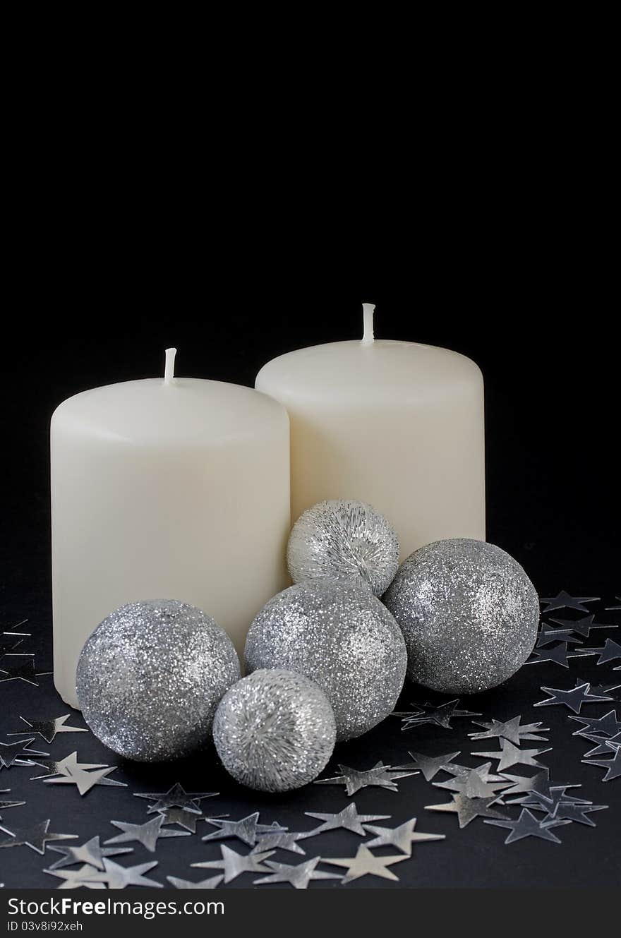 Two candles with silver balls