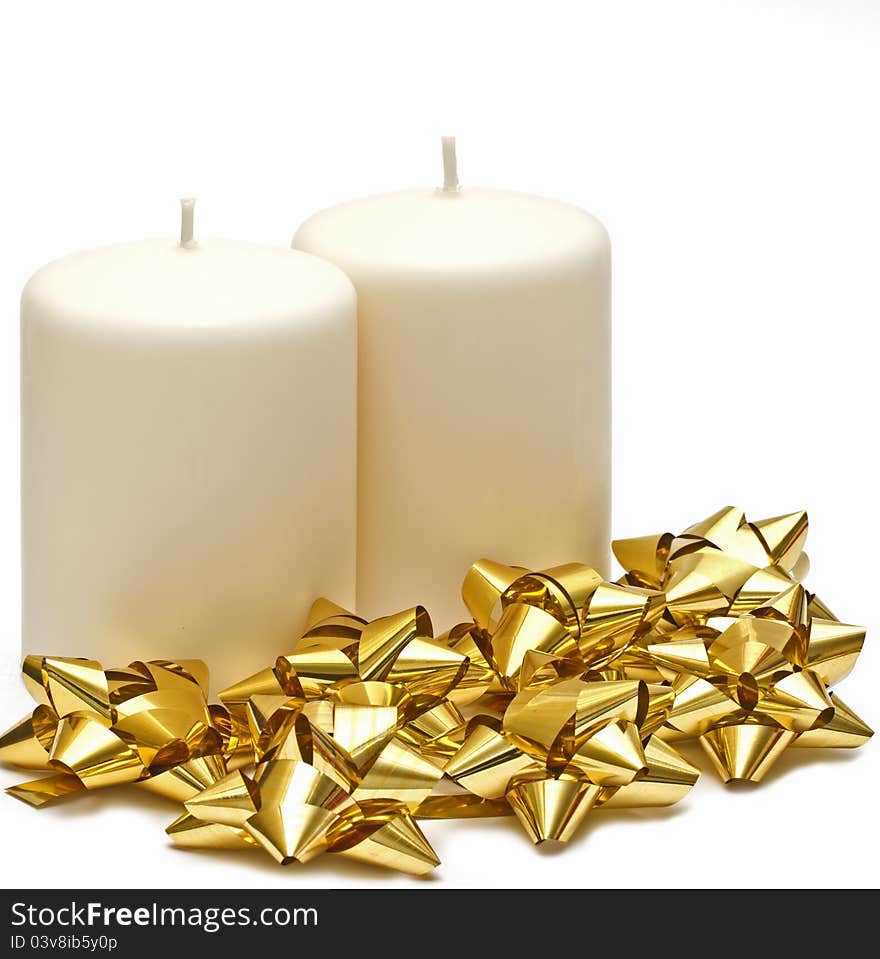 Two candles with gold bows on white background