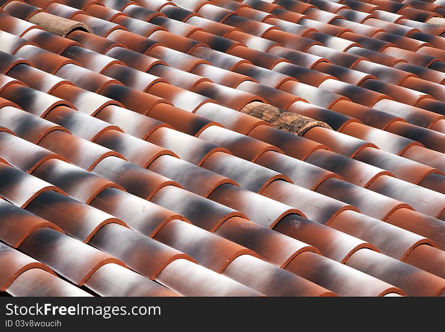 View of red roof tiles on diagonal. View of red roof tiles on diagonal