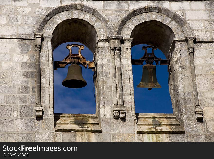 Two bells on the tower against the blue sky. Two bells on the tower against the blue sky