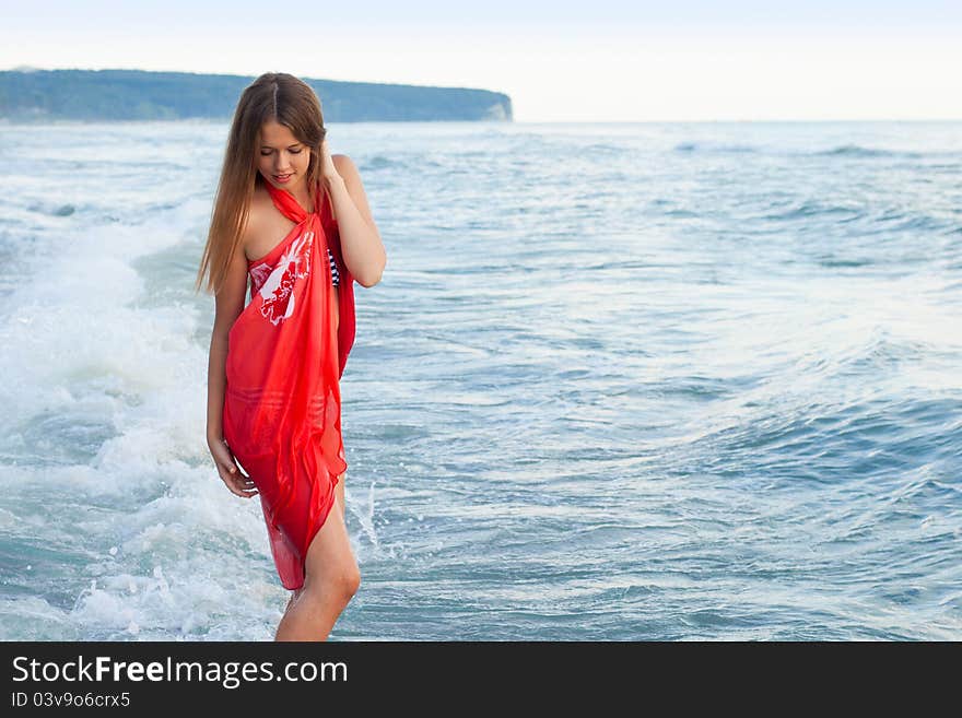 Young girl in a pareo on the sea. Young girl in a pareo on the sea