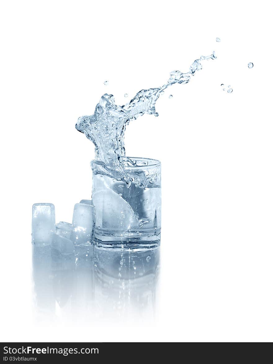 Few ice cubes near glass of splashing water on white background. Isolated with clipping path. Few ice cubes near glass of splashing water on white background. Isolated with clipping path