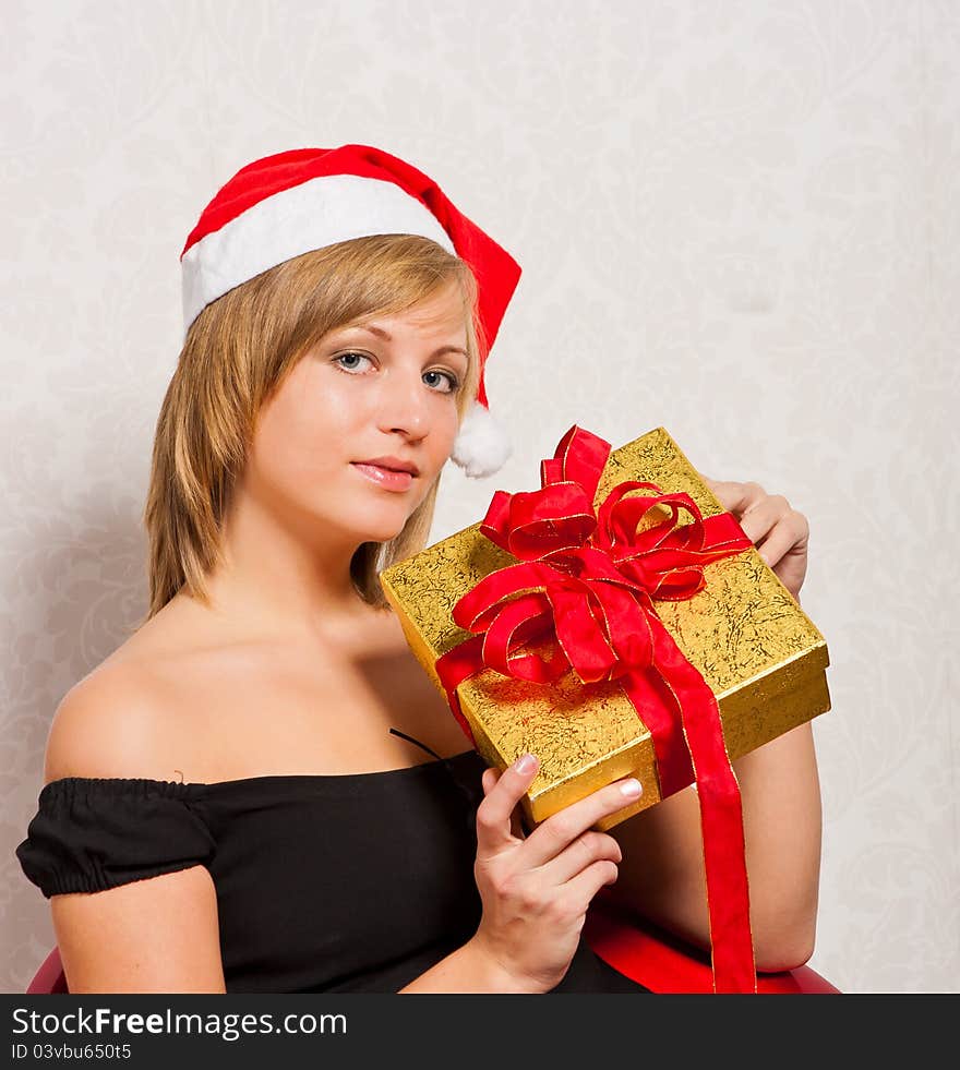 Beutiful young woman with gold gift box. Beutiful young woman with gold gift box