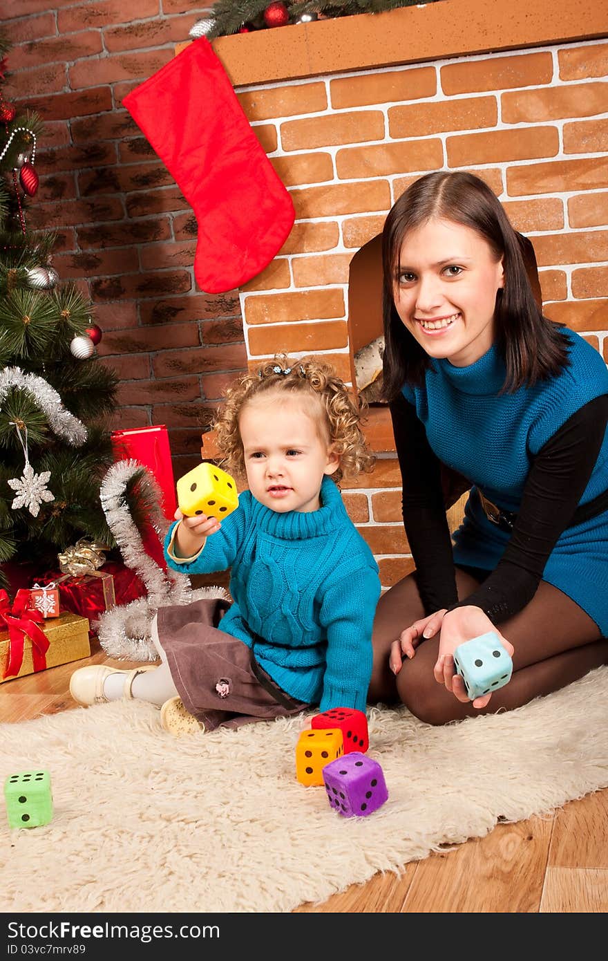 Mother And Her Daughter Near Christmas Tree