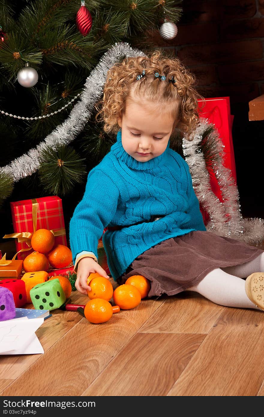 Little girl near Christmas tree