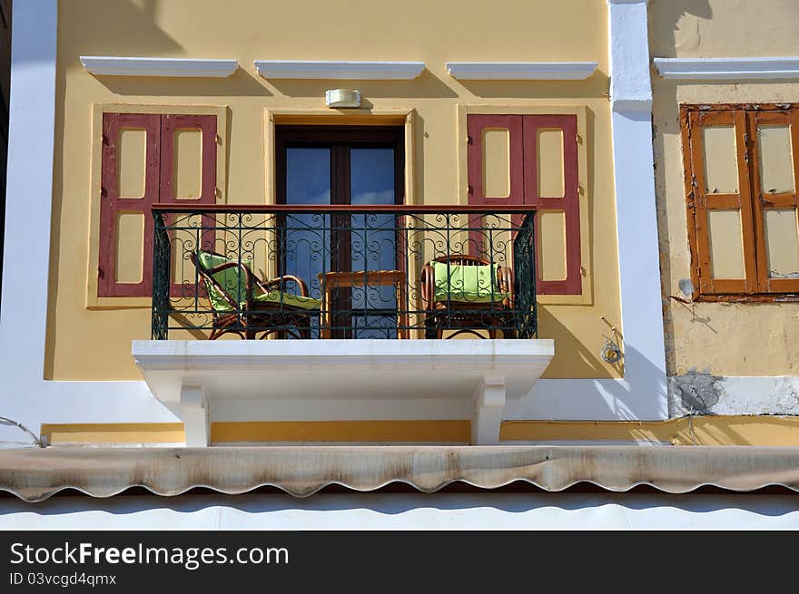 Beautiful sun drenched balcony on the greek island of symi, typical of the mediterranean region. Beautiful sun drenched balcony on the greek island of symi, typical of the mediterranean region