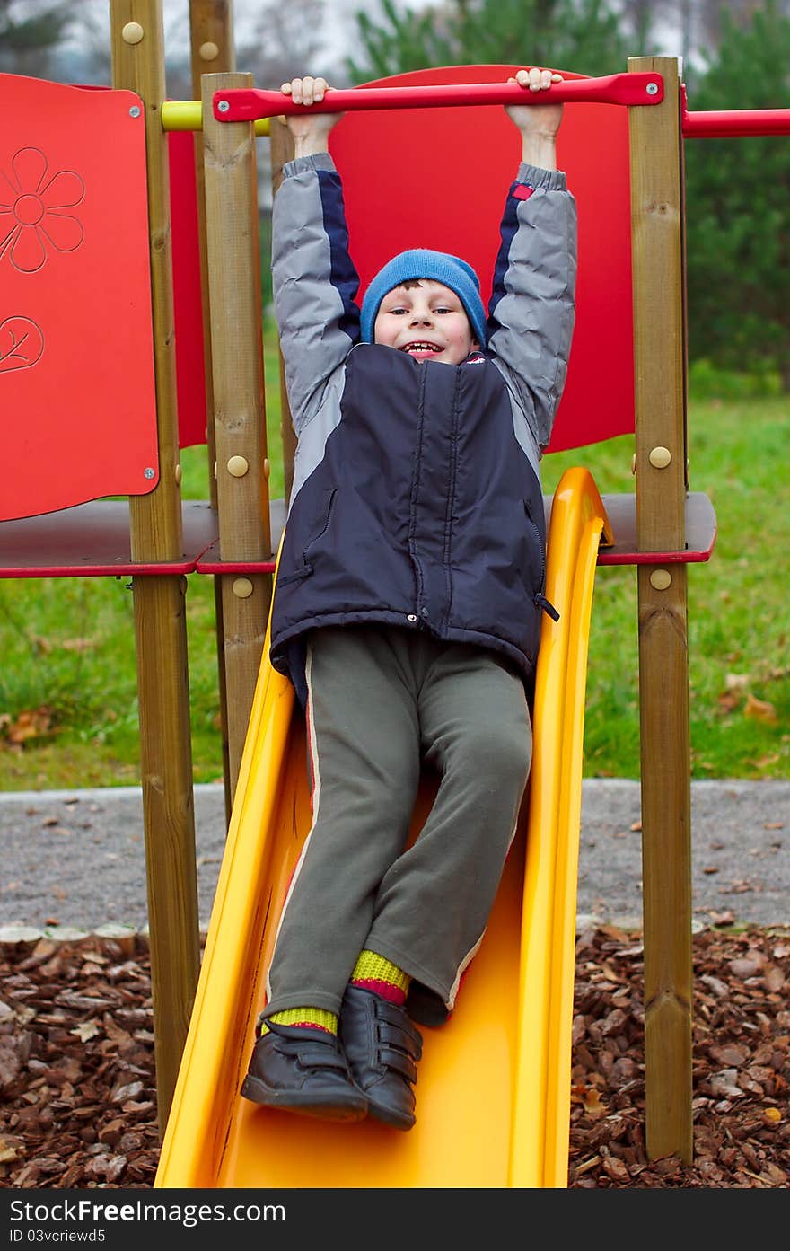 Happy smiling child in playground vertical