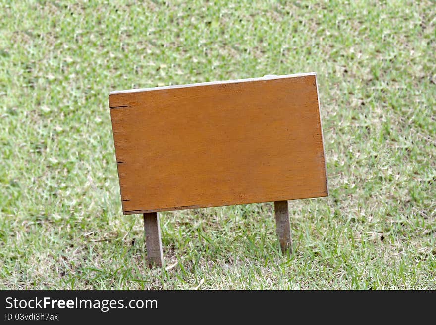 Wooden sign on grassland