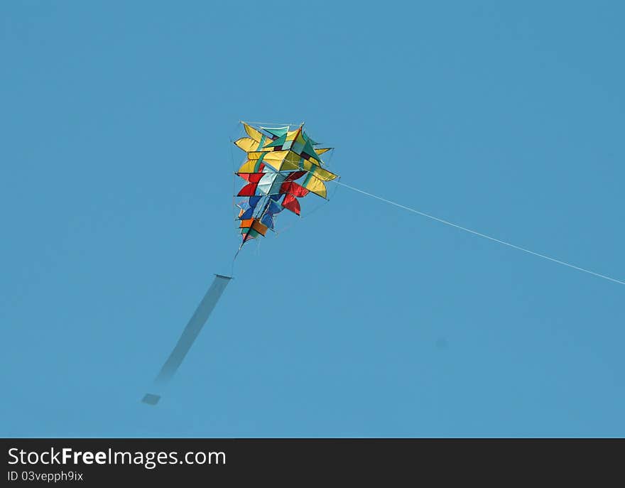 A colorful kite against a blue sky. A colorful kite against a blue sky.