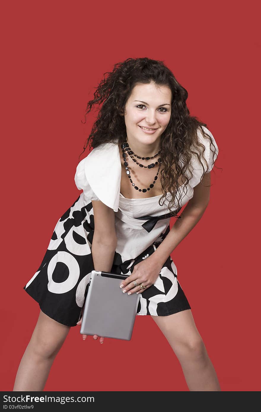 Young woman and tablet pc, with smle and  red background