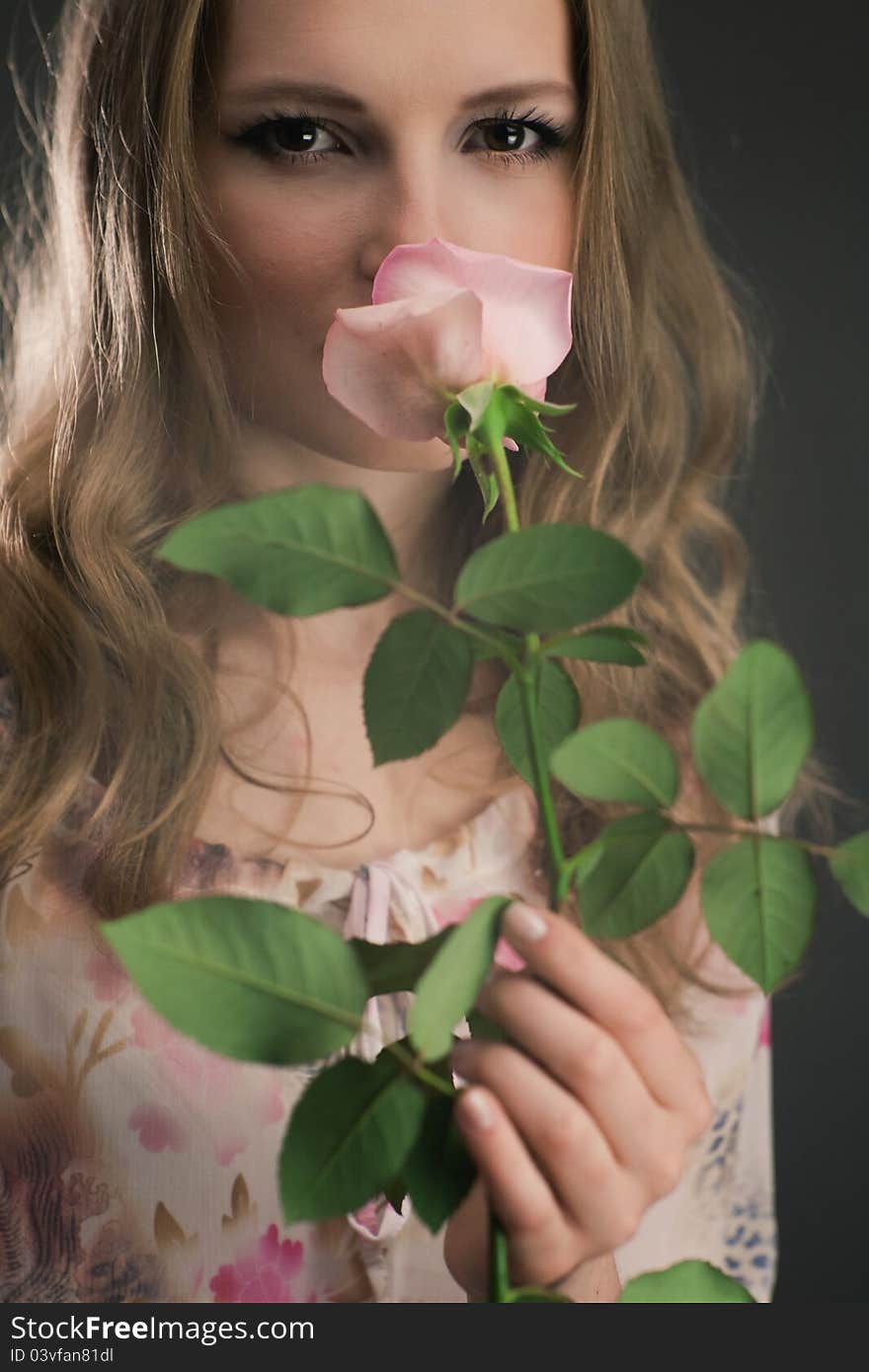 Portrait of young girl that holds delicate rose. Portrait of young girl that holds delicate rose