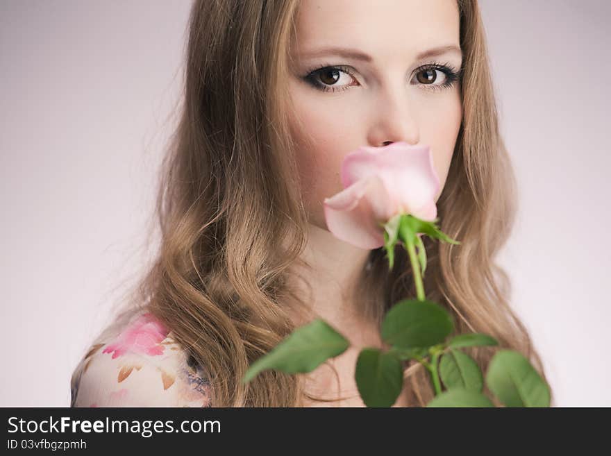 Portrait of young girl that holds delicate rose. Portrait of young girl that holds delicate rose