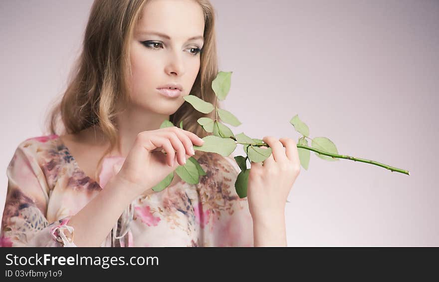 Portrait of young girl that holds delicate rose. Portrait of young girl that holds delicate rose