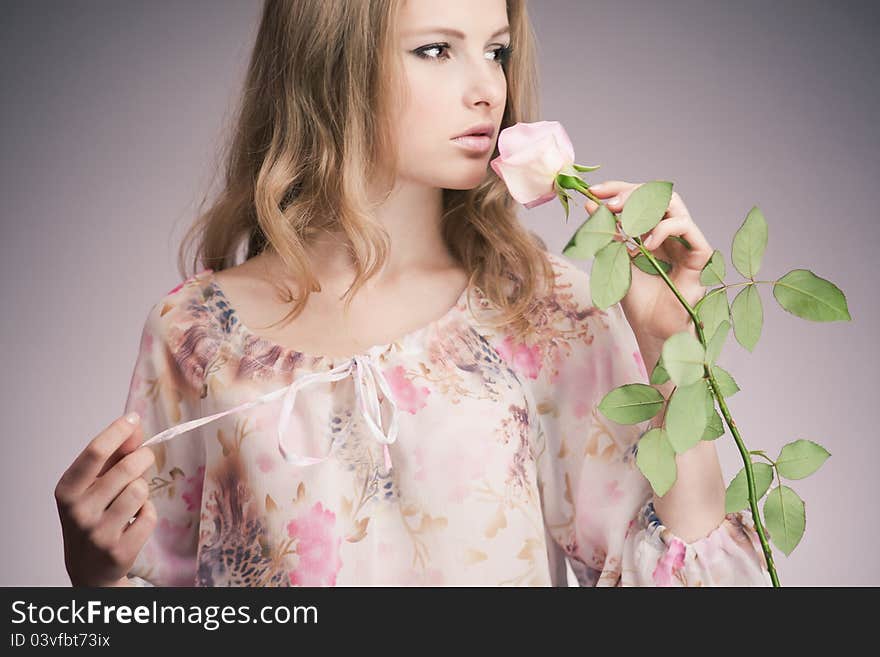 Portrait of young girl that holds delicate rose. Portrait of young girl that holds delicate rose