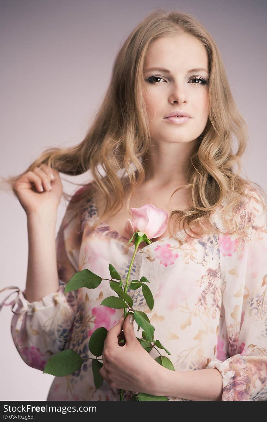 Portrait of young girl that holds delicate rose. Portrait of young girl that holds delicate rose