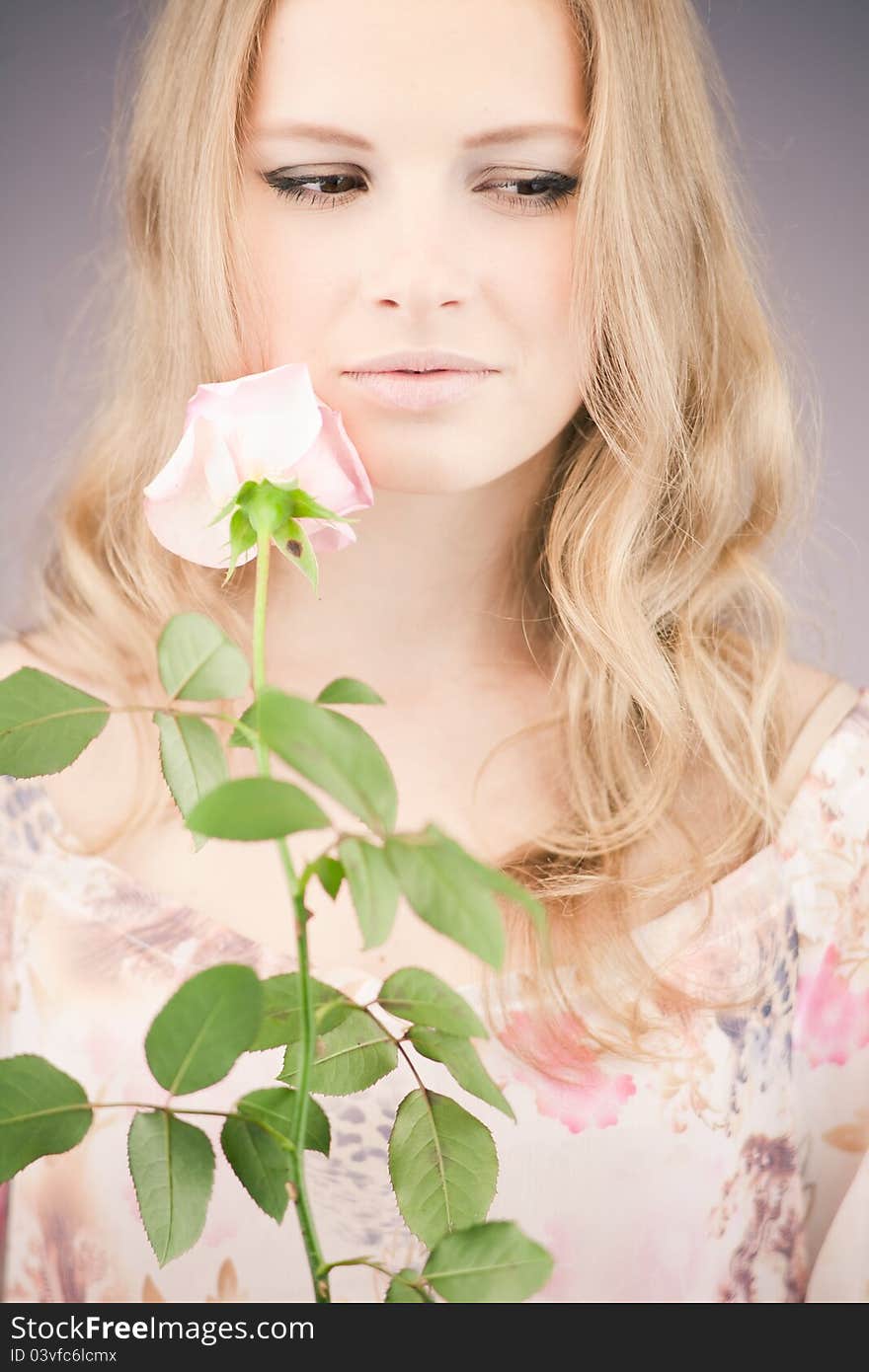 Portrait of young girl that holds delicate rose. Portrait of young girl that holds delicate rose