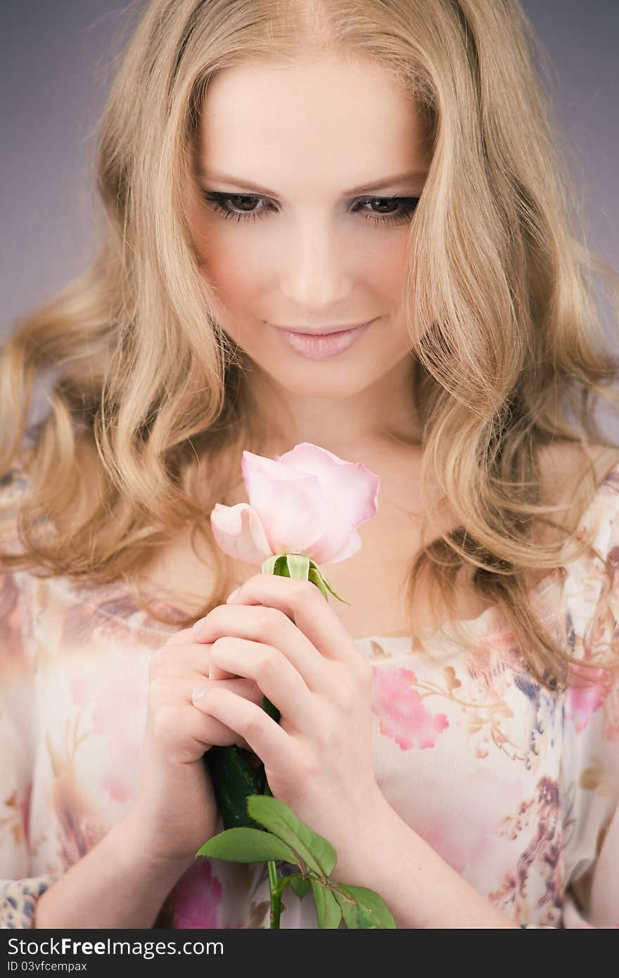 Portrait of young girl that holds delicate rose. Portrait of young girl that holds delicate rose