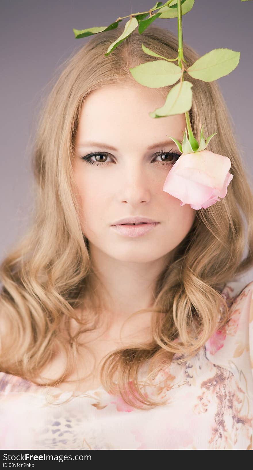 Portrait of young girl that holds delicate rose. Portrait of young girl that holds delicate rose