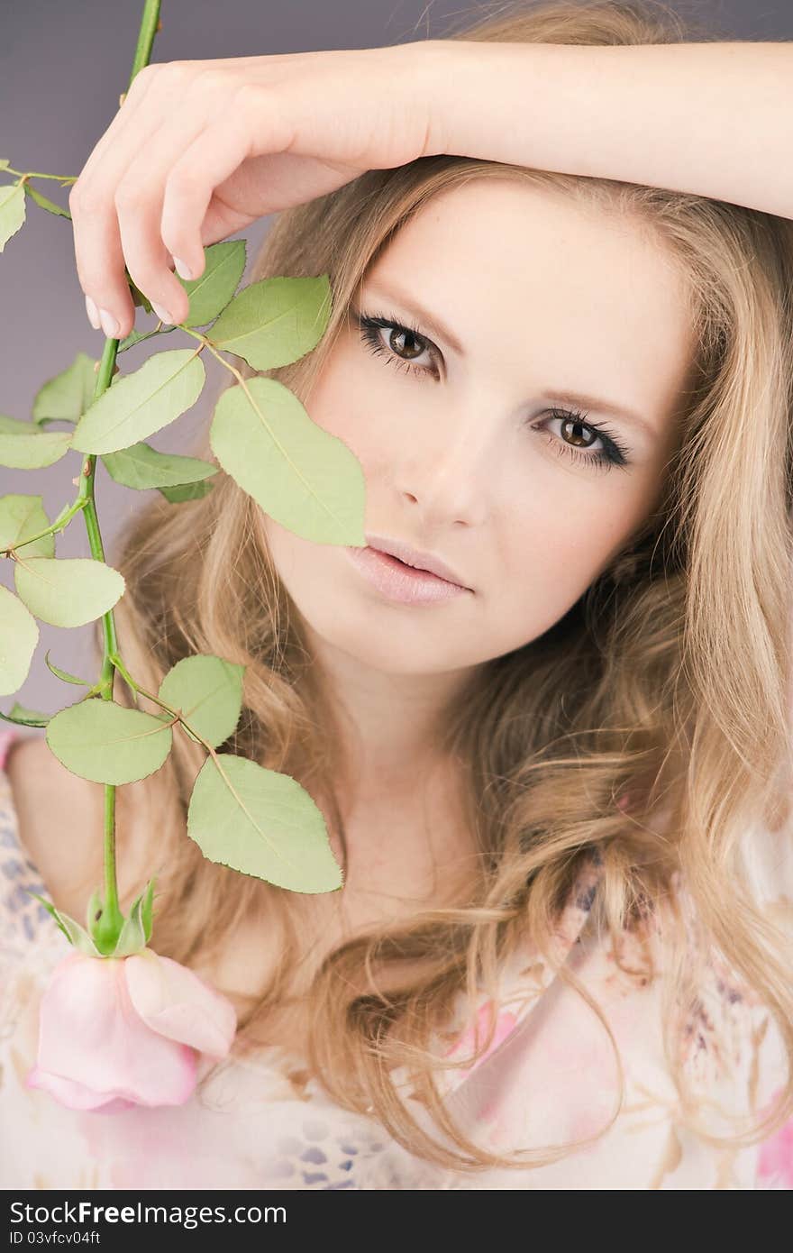 Portrait of young girl that holds delicate rose. Portrait of young girl that holds delicate rose