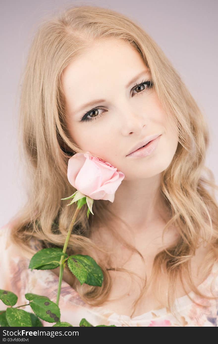 Portrait of young girl that holds delicate rose. Portrait of young girl that holds delicate rose