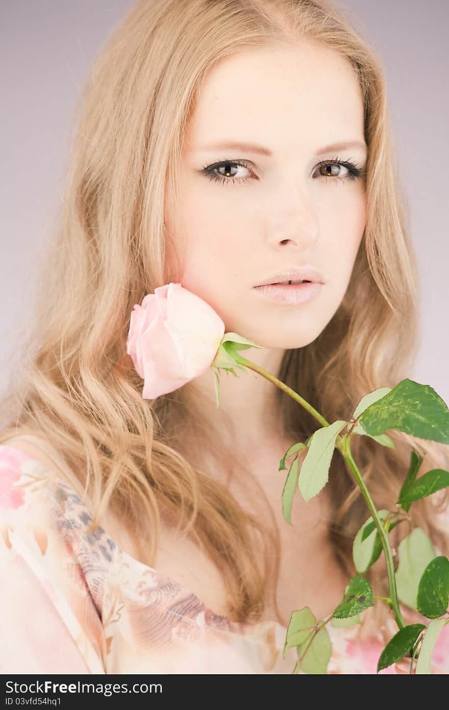 Portrait of young girl that holds delicate rose. Portrait of young girl that holds delicate rose