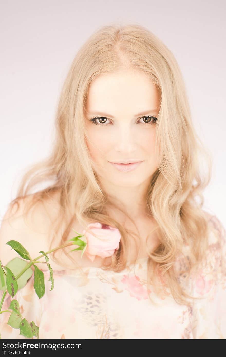 Portrait of young girl that holds delicate rose. Portrait of young girl that holds delicate rose