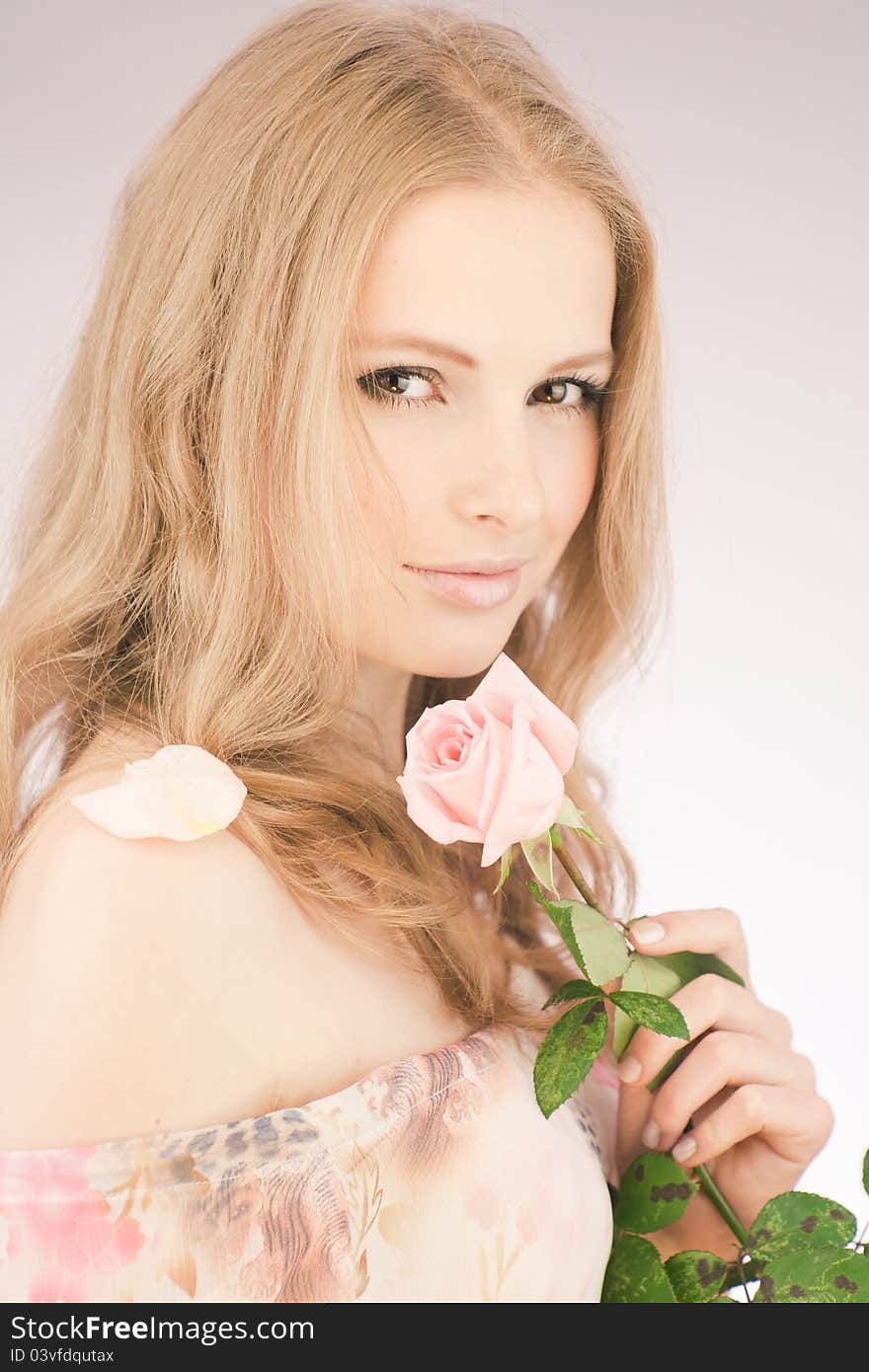 Portrait of young girl that holds delicate rose. Portrait of young girl that holds delicate rose