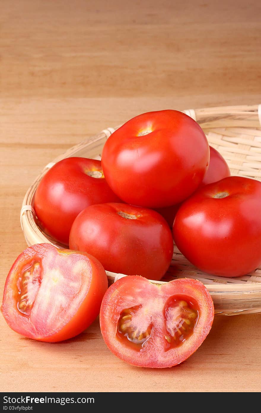 Fresh tomato on wooden table top