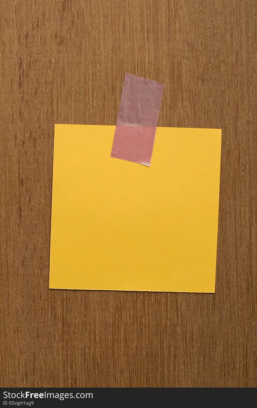 Blank yellow note on wood texture. You can put your image on the note