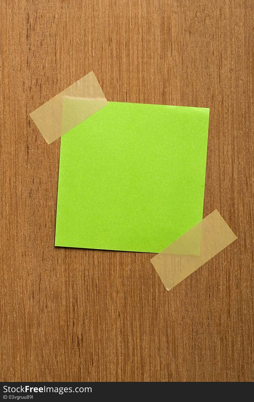 Blank yellow note on wood texture. You can put your image on the note