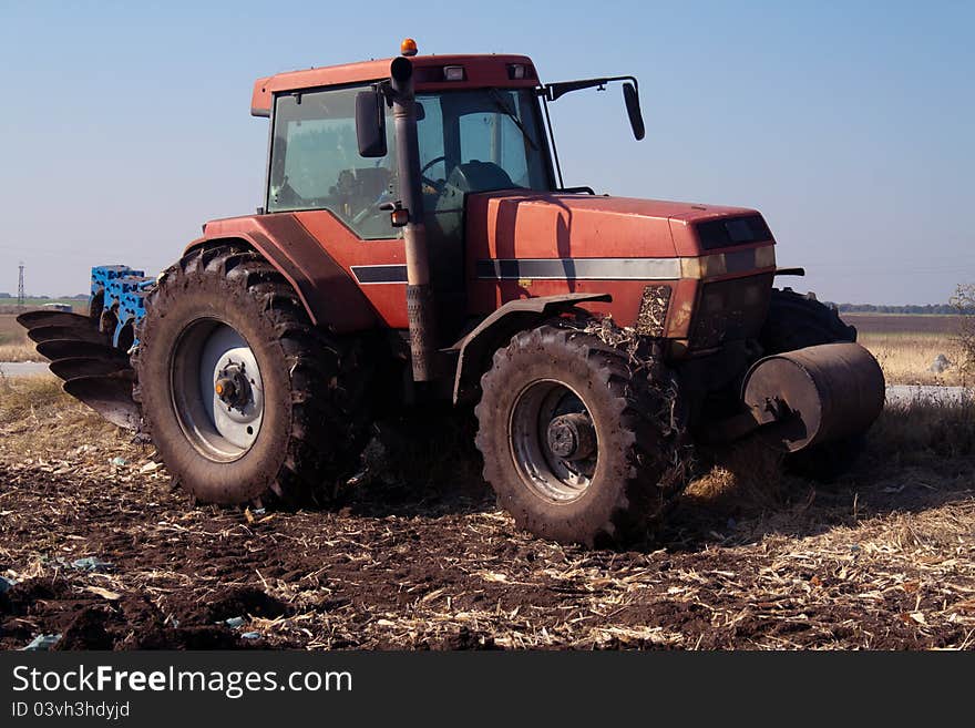 Red tractor at work on farm