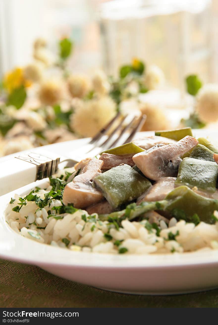 Chicken with mushrooms, green beans and rice in cream sauce. Chicken with mushrooms, green beans and rice in cream sauce