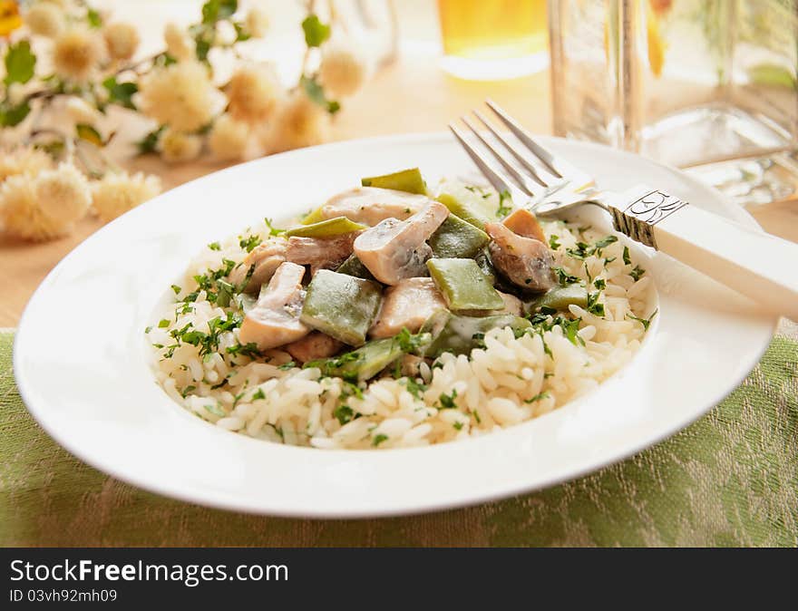 Chicken with mushrooms, green beans and rice in cream sauce. Chicken with mushrooms, green beans and rice in cream sauce