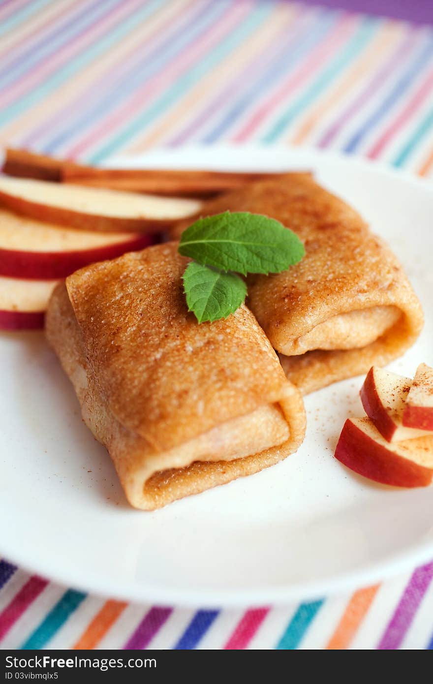 Apple and cinnamon pancakes on a white plate. Apple and cinnamon pancakes on a white plate