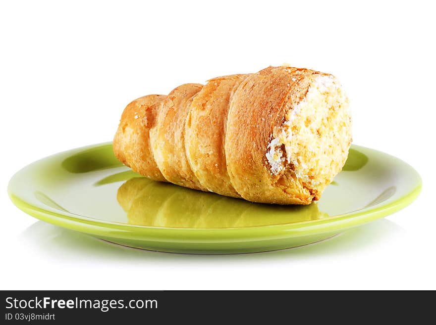 Cakes, rolls with cream on the dessert plate. Cakes, rolls with cream on the dessert plate.