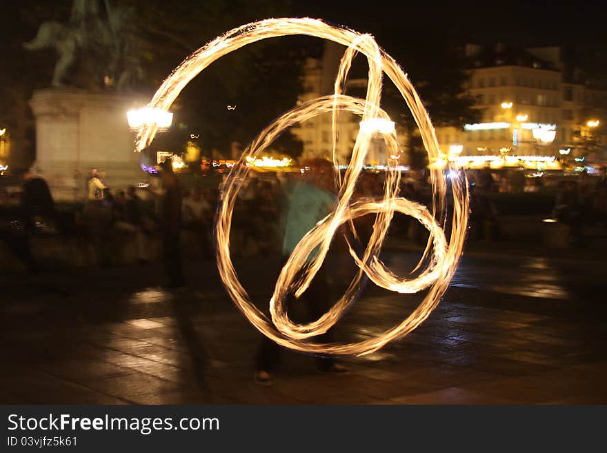 One of the group of fire dancers performing in front of Notre Dame Cathedral in Paris