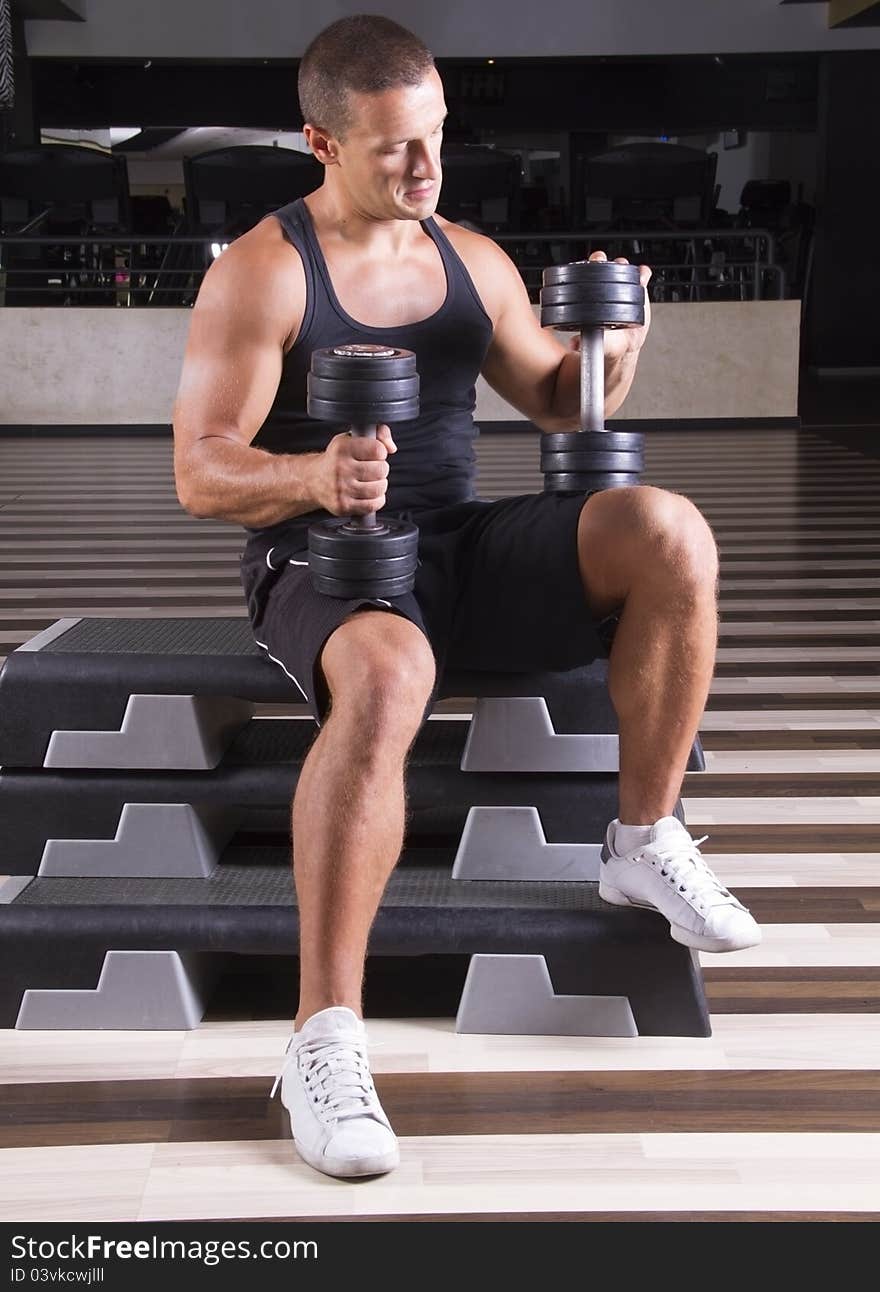 Fitness instructor setting up his weights