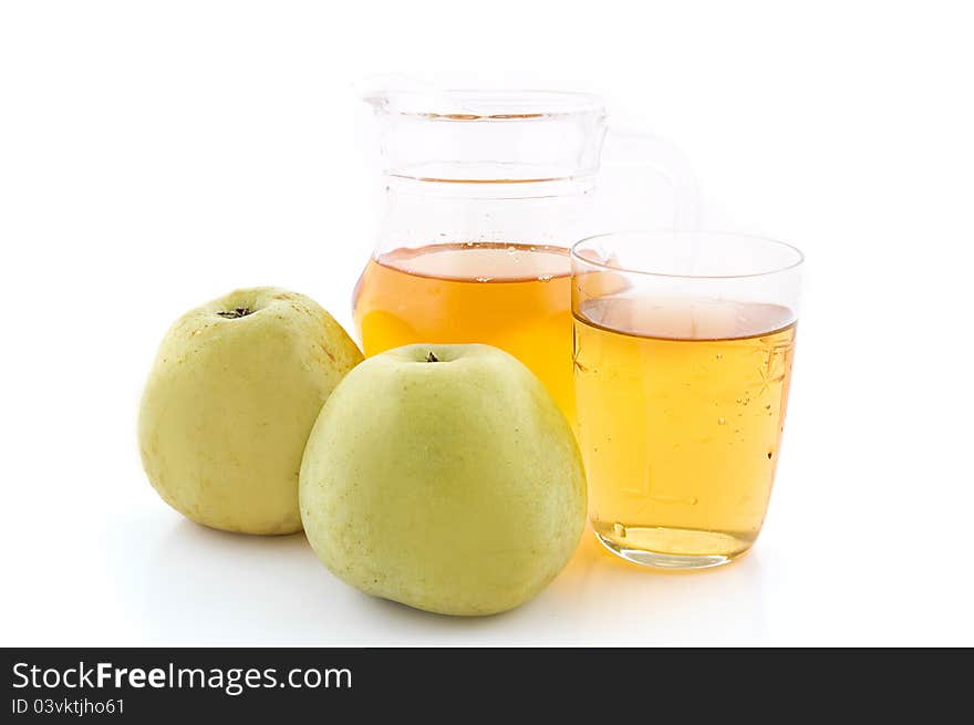 Jug and glass of green apple juice with fruit on white background